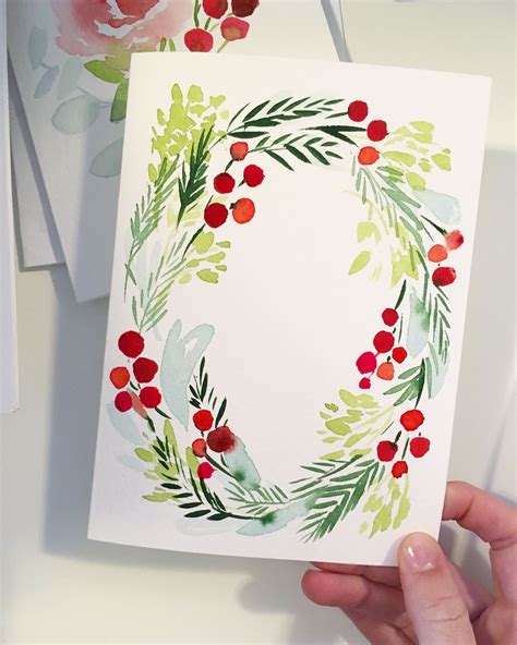Watercolor christmas cards - This ornament is decorated with some stunningly beautiful floral watercolor art that bends with the shape of the circle perfectly. The colours are non-traditional Christmas colours, but still definitely bring the holiday vibe! by @drexelbarbara. This idea is great for a piece of hanging art prints or a holiday card!